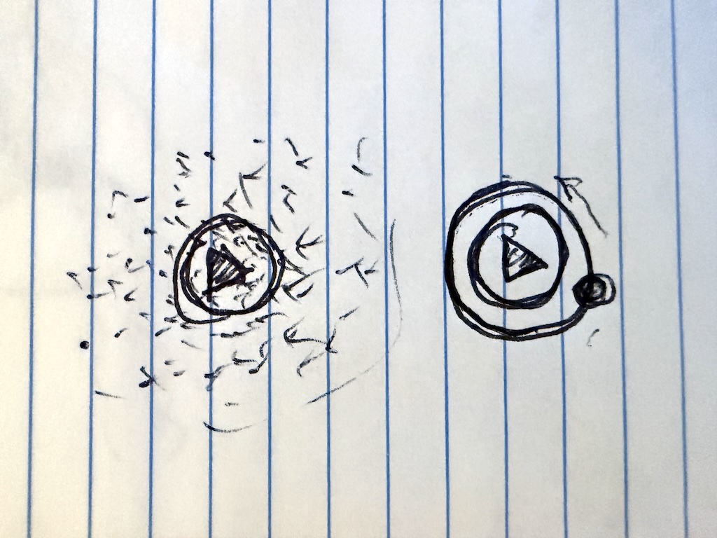 My original notebook sketch: a circular Play button surrounded by scattered particles beside a second version with an orbital ring.